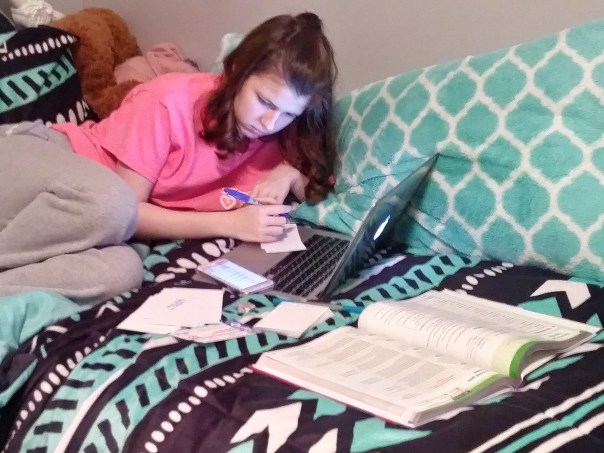 Ashley Scrivner is hard at work, completing her homework in preparation to move up to her last year of high school where she will be taking five dual college classes.